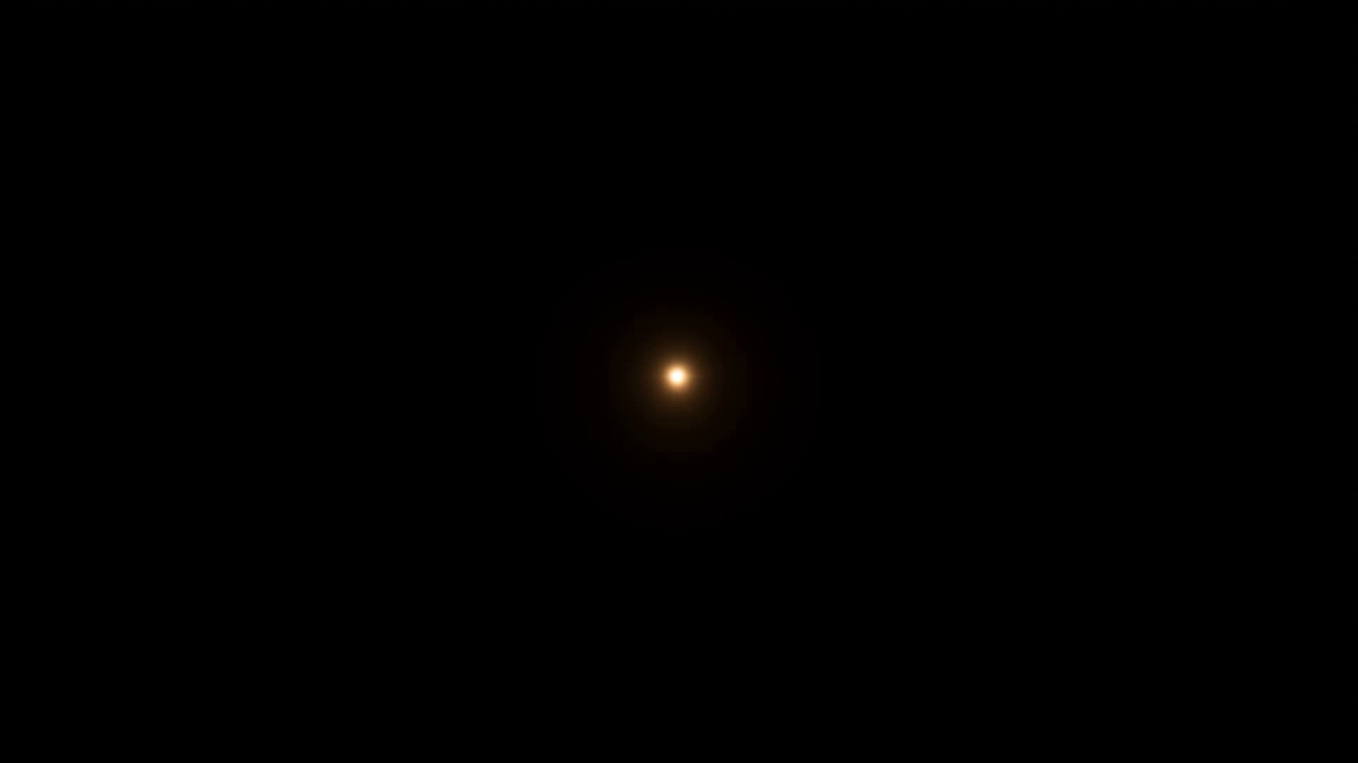 A single point of gold light alone in black space: the seed of a structure that has not yet begun to assemble.